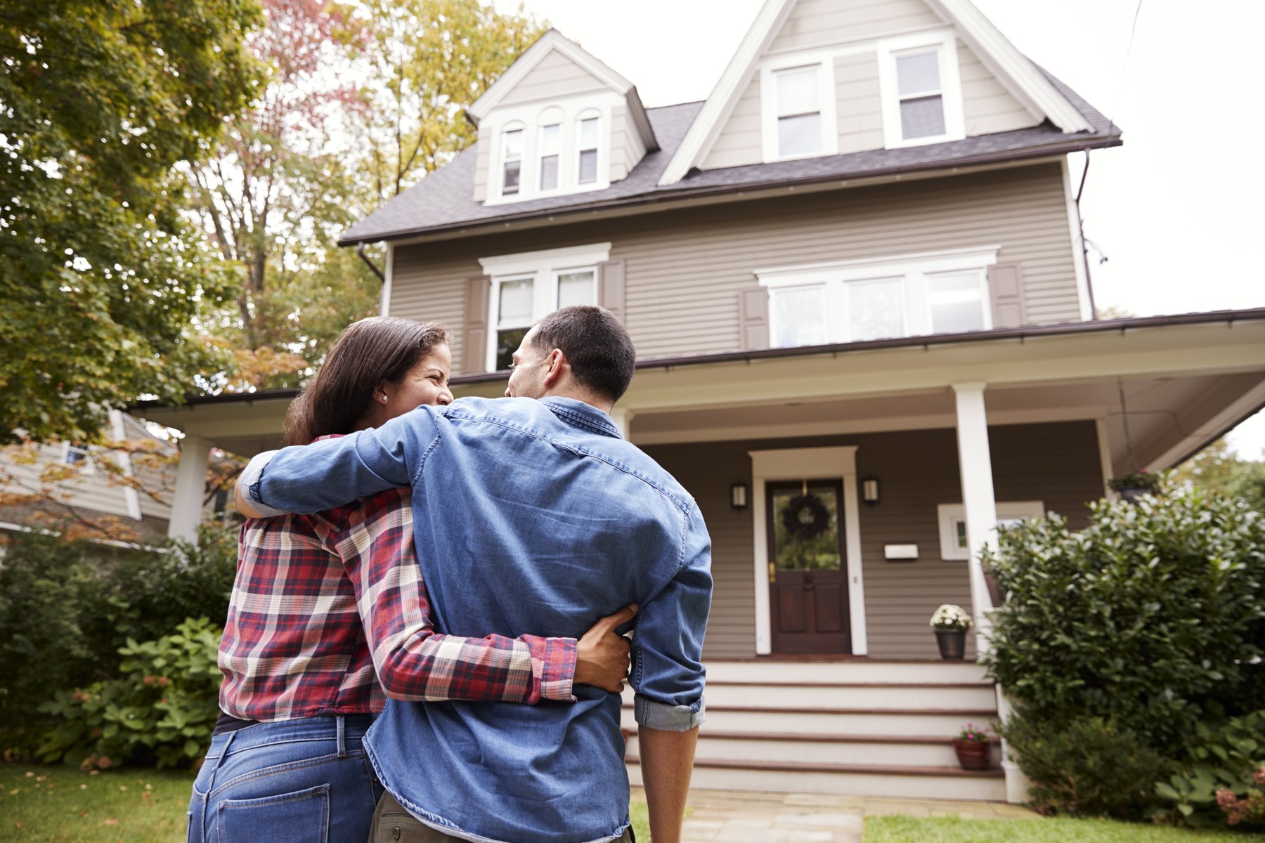 A happy GeoBrix customer in front of their finished home